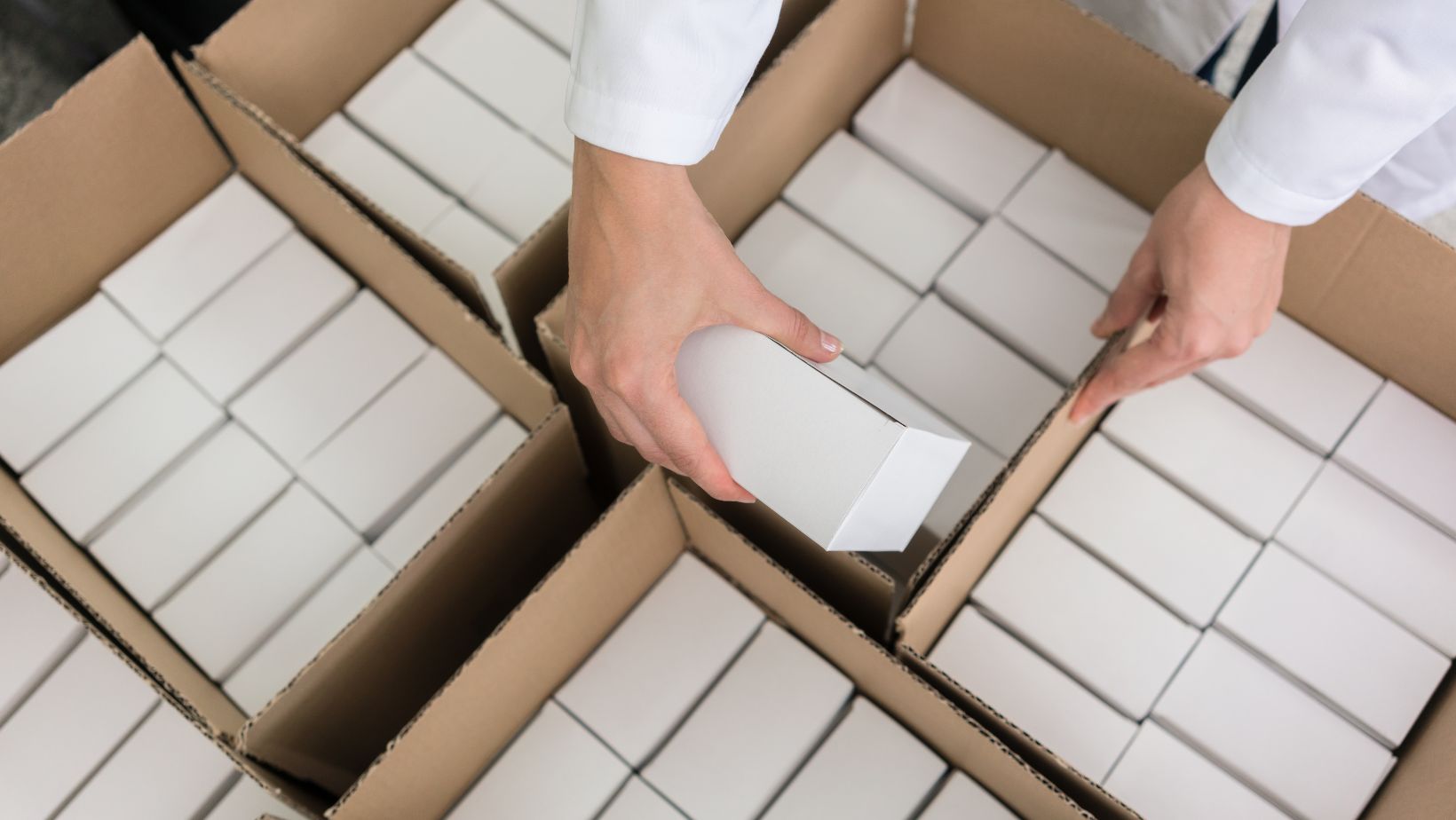 person taking out small boxes out of bigger boxes