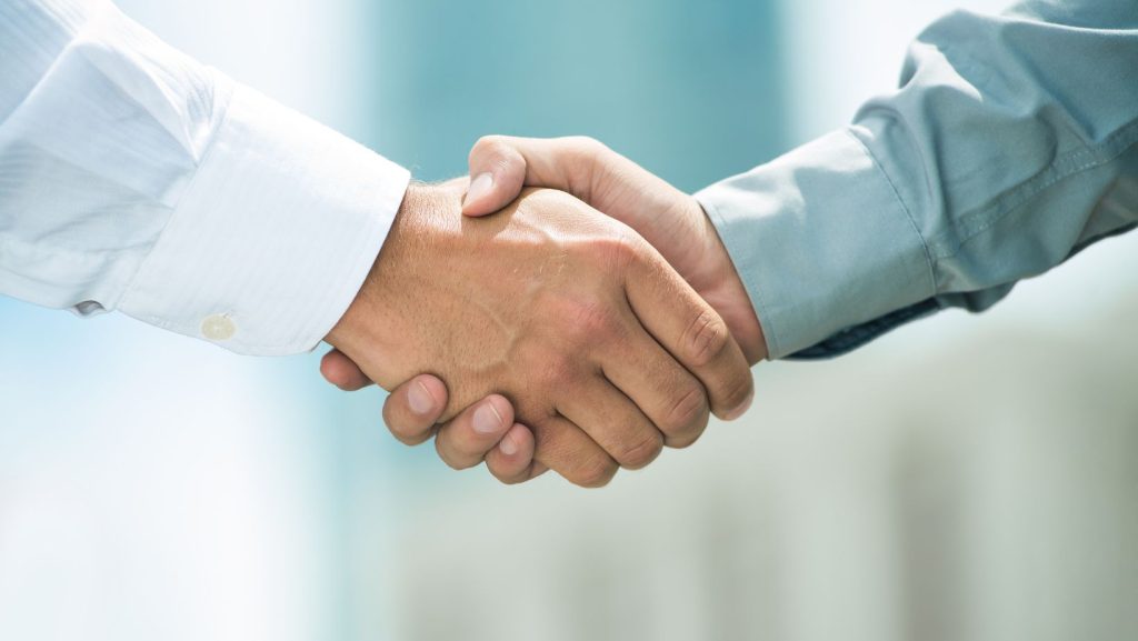 A close up of two shaking hands.