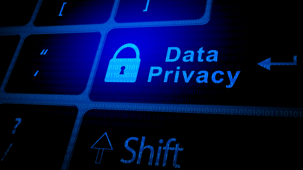 Data Privacy written on a keyboard with neon blue light in the background